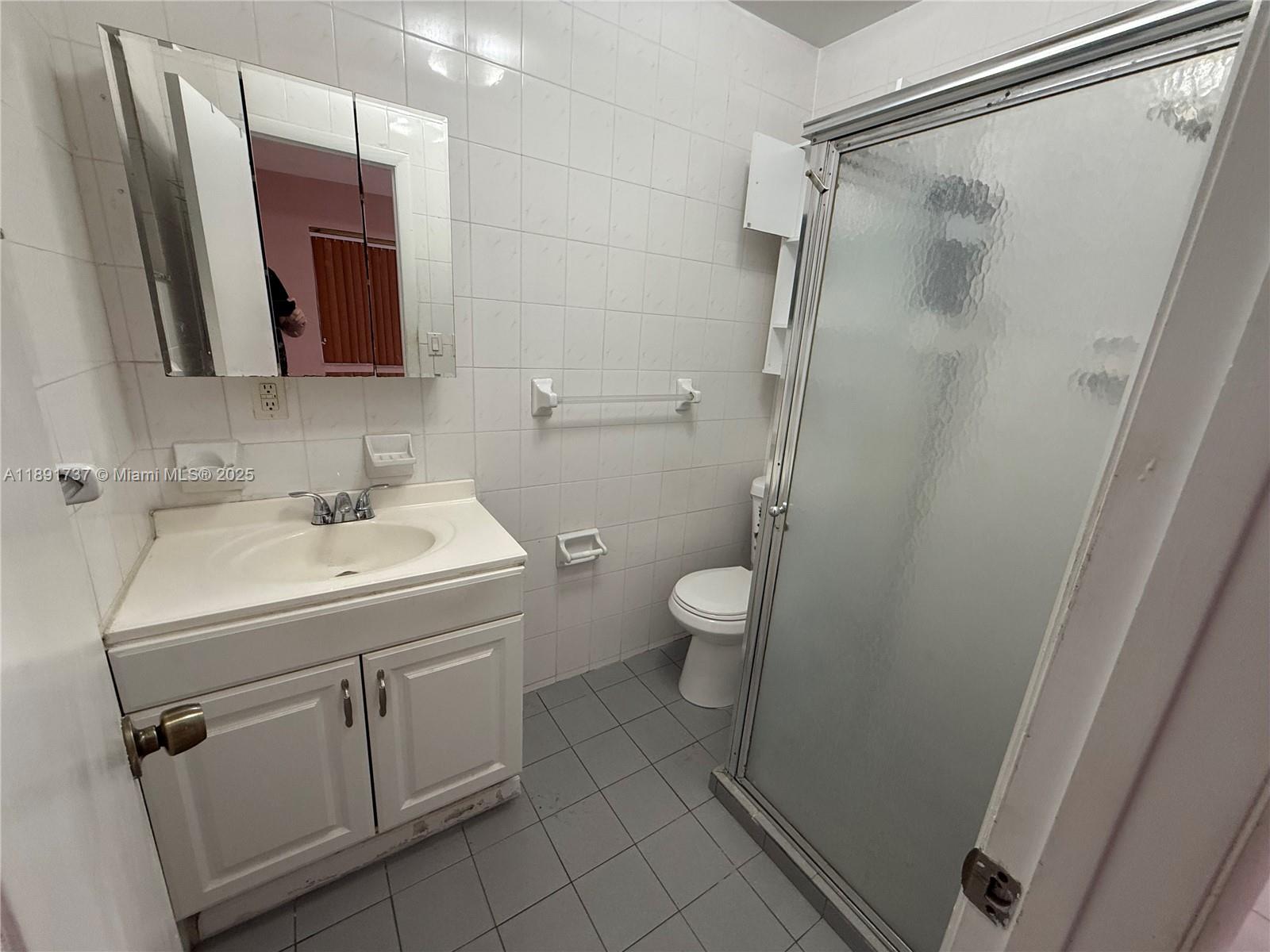 3450 Southwest 75th Court Miami, FL 33155 - Photo 18 of 22 a bathroom with a sink a toilet and shower