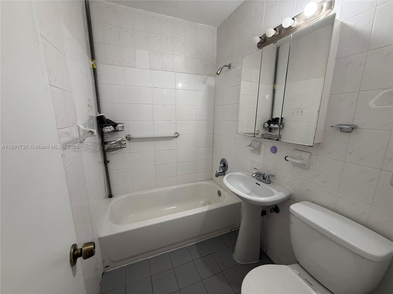3450 Southwest 75th Court Miami, FL 33155 - Photo 10 of 22 a white toilet sitting next to a bath tub