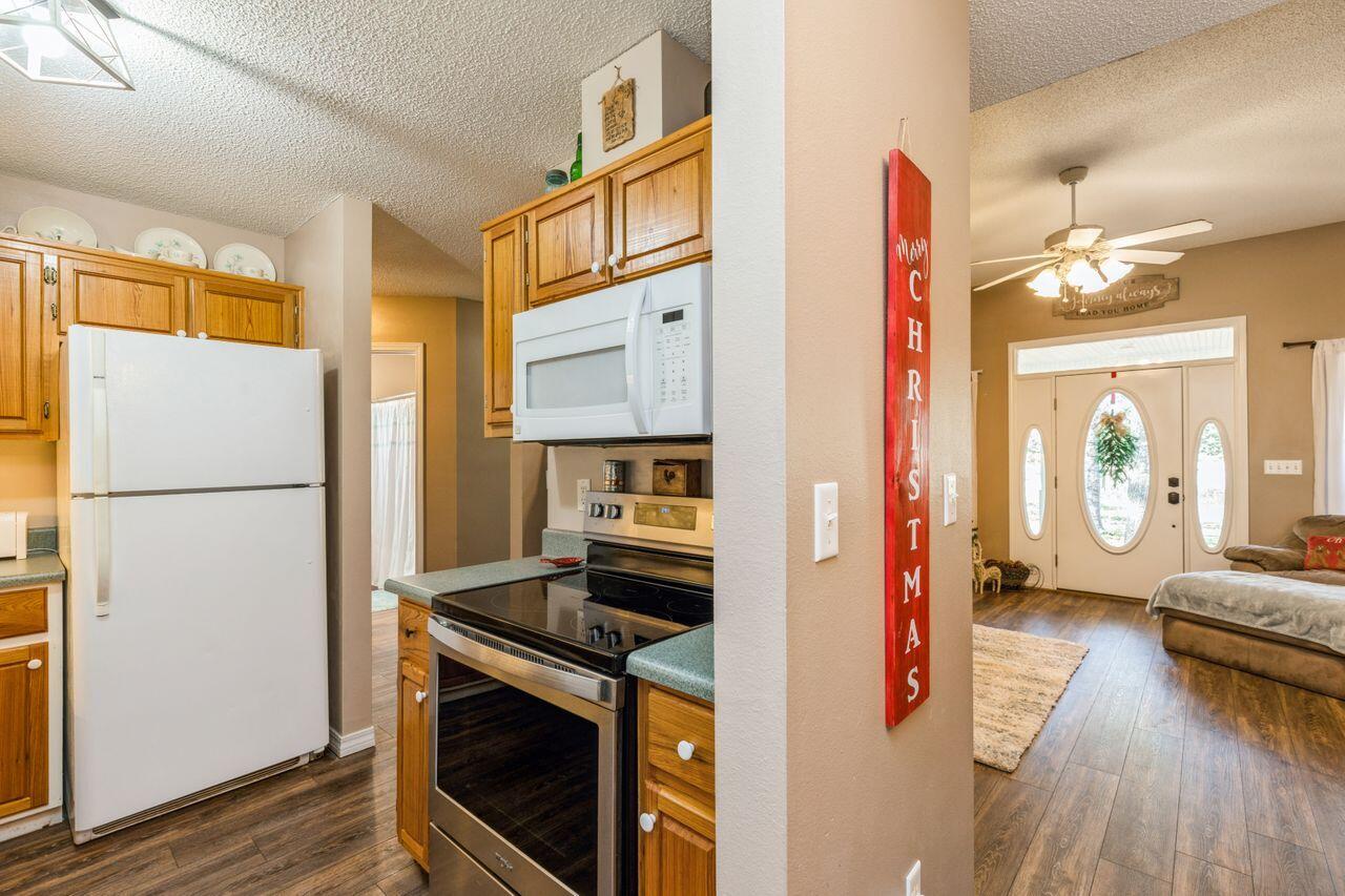 6391 Lumber Ridge Road Crestview, FL 32539 - Photo 11 of 48 a kitchen with a refrigerator and a stove top oven