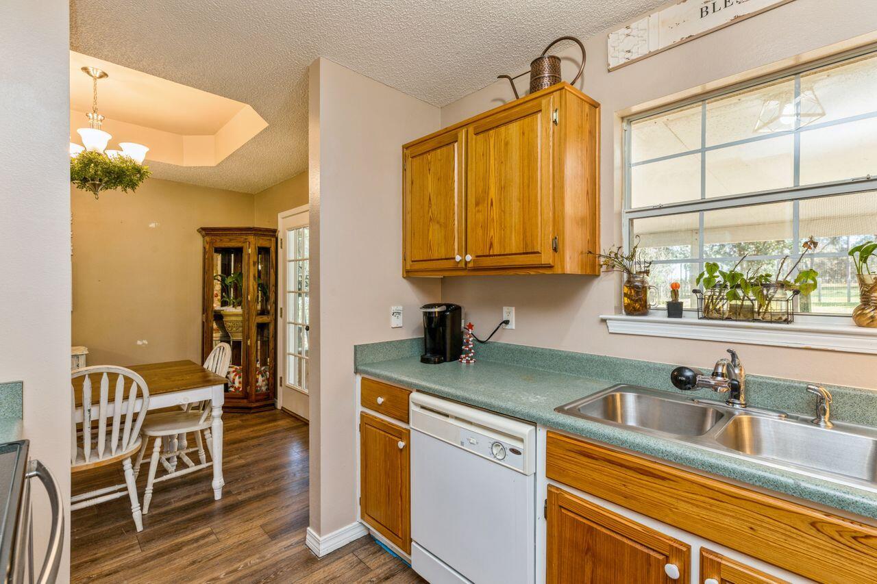 6391 Lumber Ridge Road Crestview, FL 32539 - Photo 12 of 48 a kitchen with a sink cabinets and window