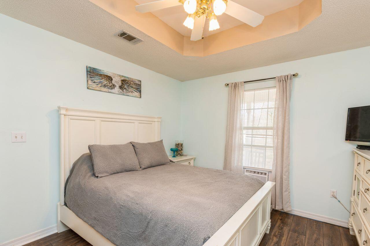 6391 Lumber Ridge Road Crestview, FL 32539 - Photo 13 of 48 a bedroom with a bed and a flat tv screen on dresser
