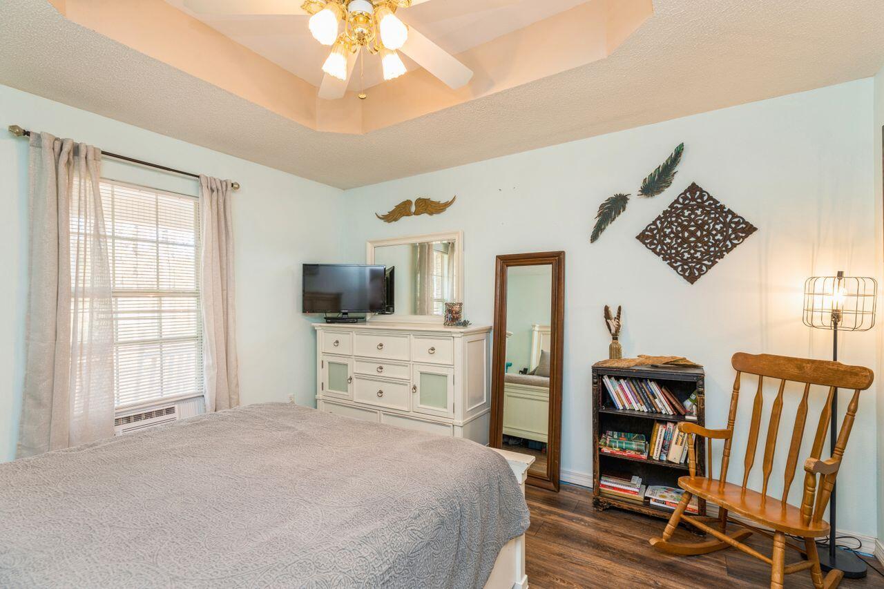 6391 Lumber Ridge Road Crestview, FL 32539 - Photo 14 of 48 a bedroom with furniture and a flat screen tv