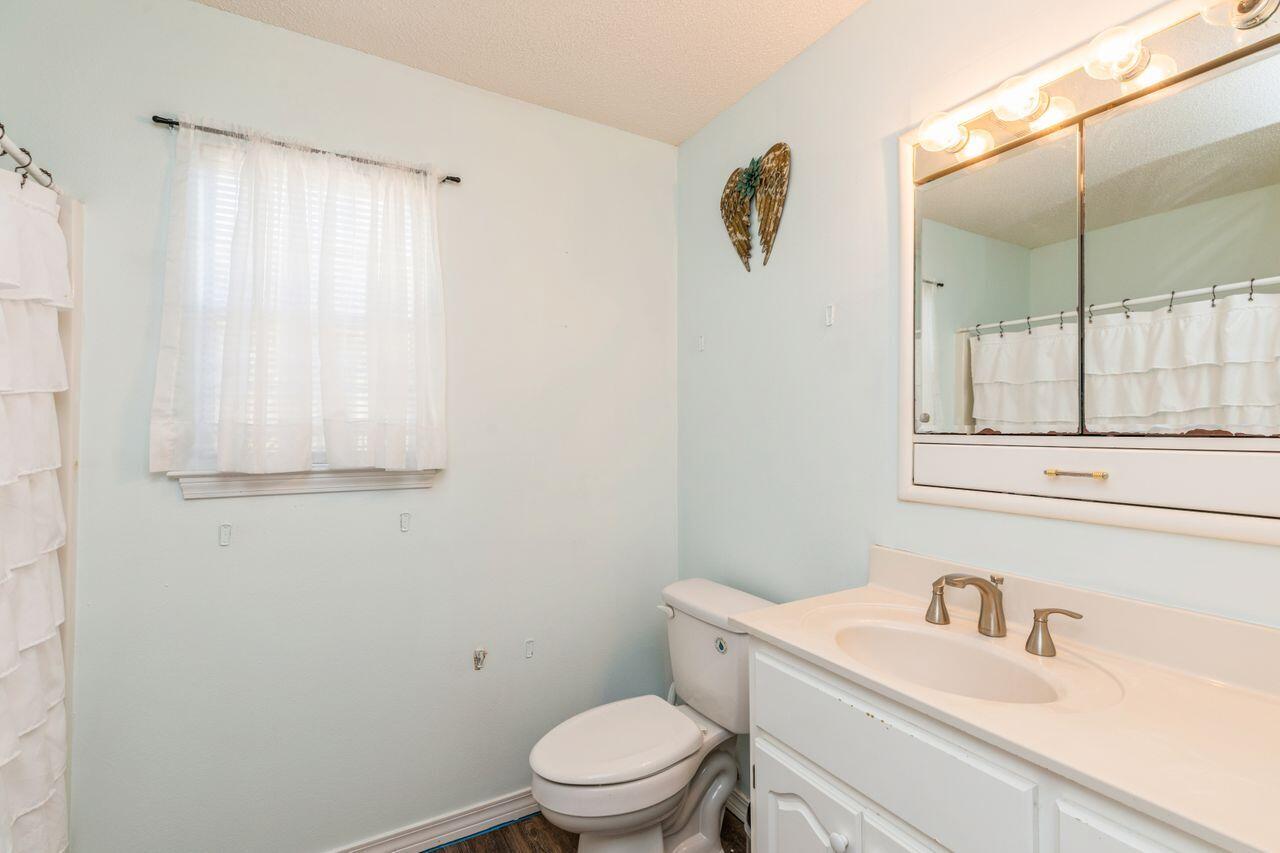 6391 Lumber Ridge Road Crestview, FL 32539 - Photo 15 of 48 a bathroom with a sink a toilet and shower