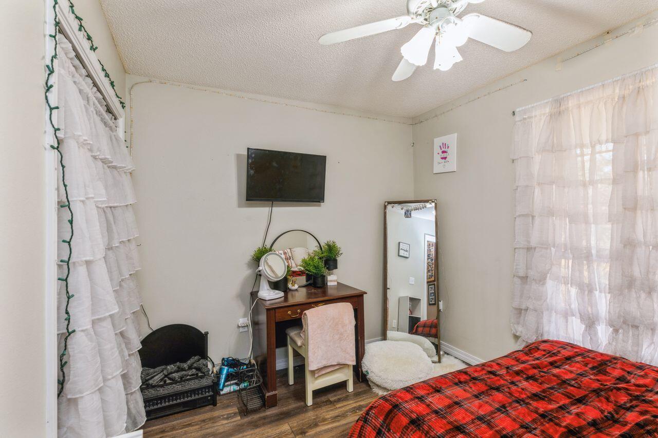6391 Lumber Ridge Road Crestview, FL 32539 - Photo 17 of 48 a bedroom with a bed and a chandelier