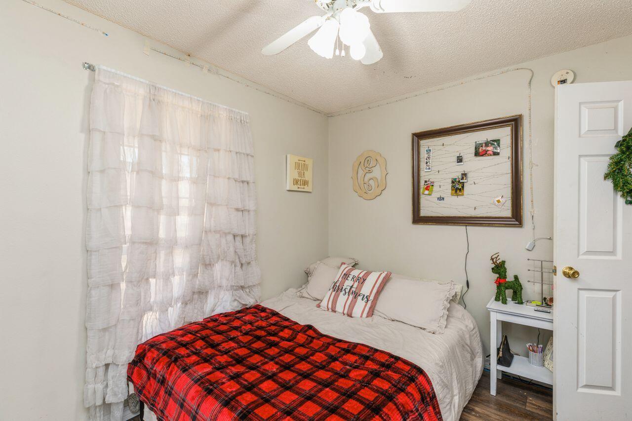 6391 Lumber Ridge Road Crestview, FL 32539 - Photo 18 of 48 a bedroom with a bed and a painting on the wall