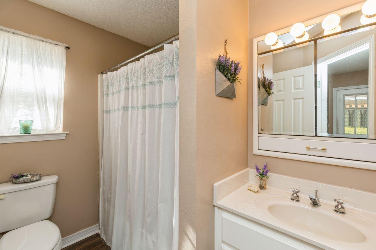 6391 Lumber Ridge Road Crestview, FL 32539 - Photo 19 of 48 a bathroom with a sink toilet and shower