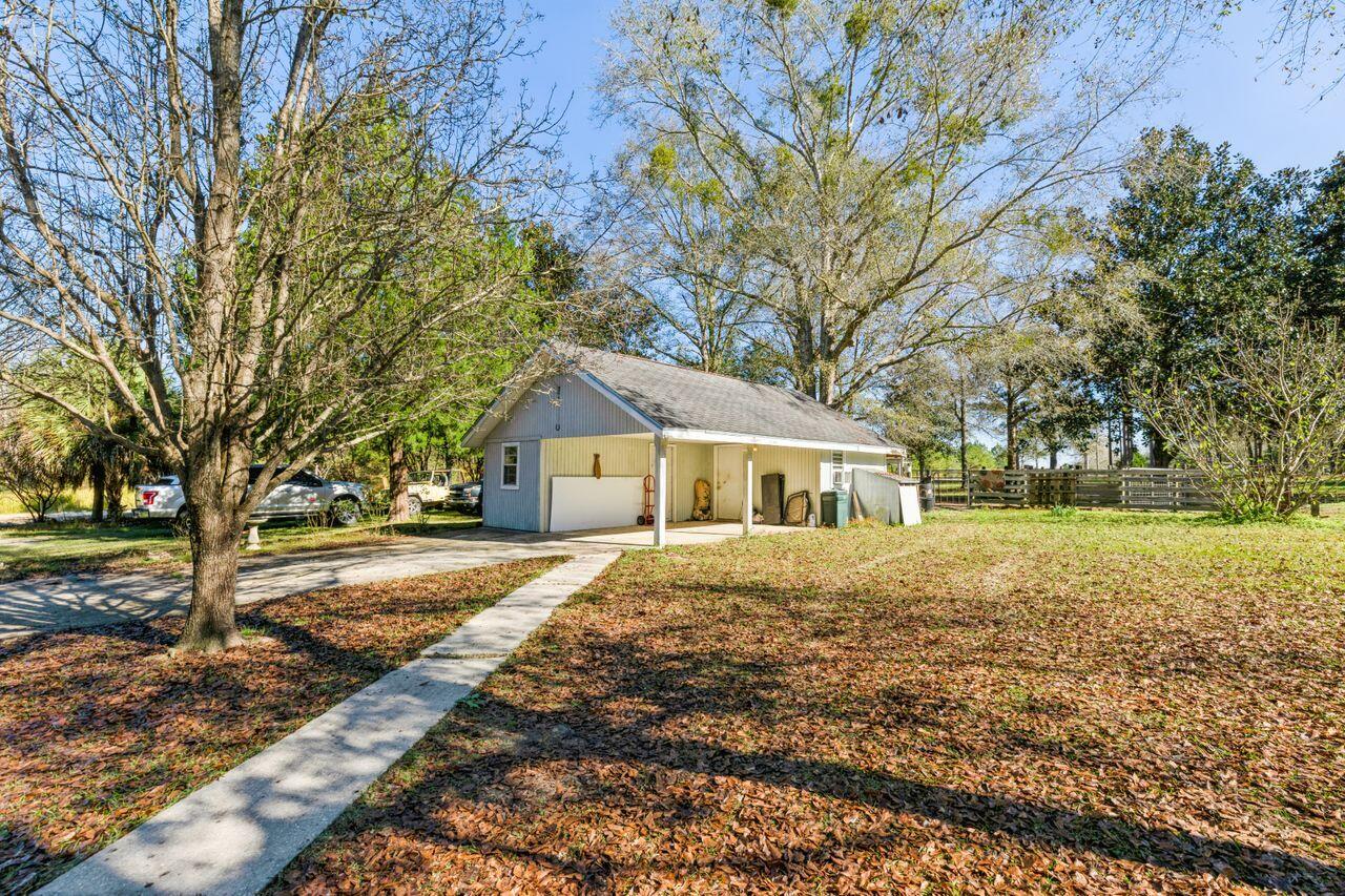 6391 Lumber Ridge Road Crestview, FL 32539 - Photo 23 of 48 a front view of a house with a yard and trees