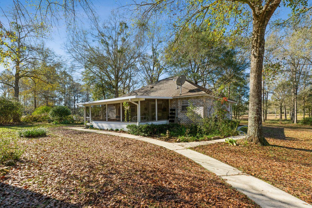 6391 Lumber Ridge Road Crestview, FL 32539 - Photo 24 of 48 a front view of a house with a yard