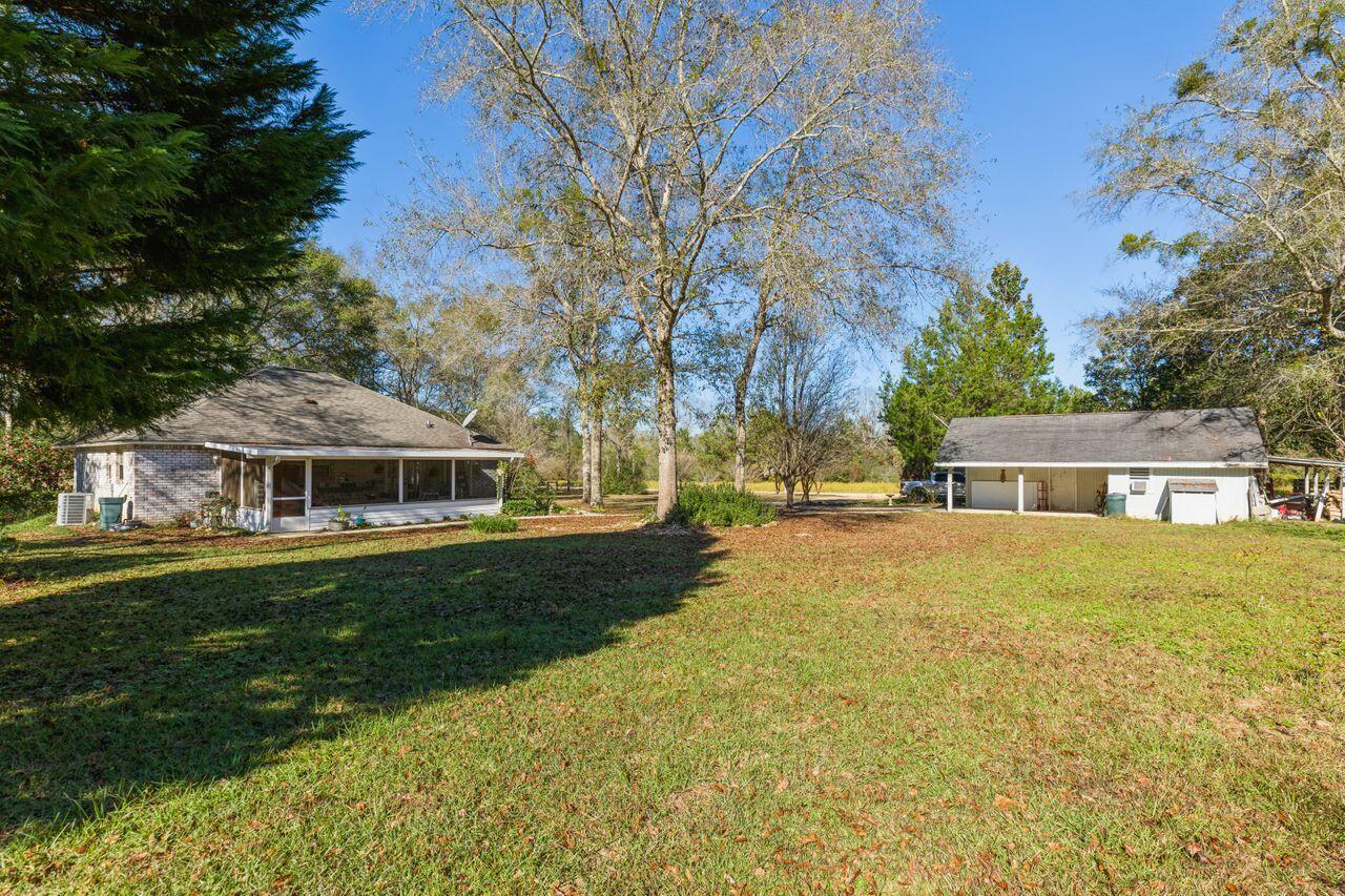 6391 Lumber Ridge Road Crestview, FL 32539 - Photo 25 of 48 a view of a house with a yard