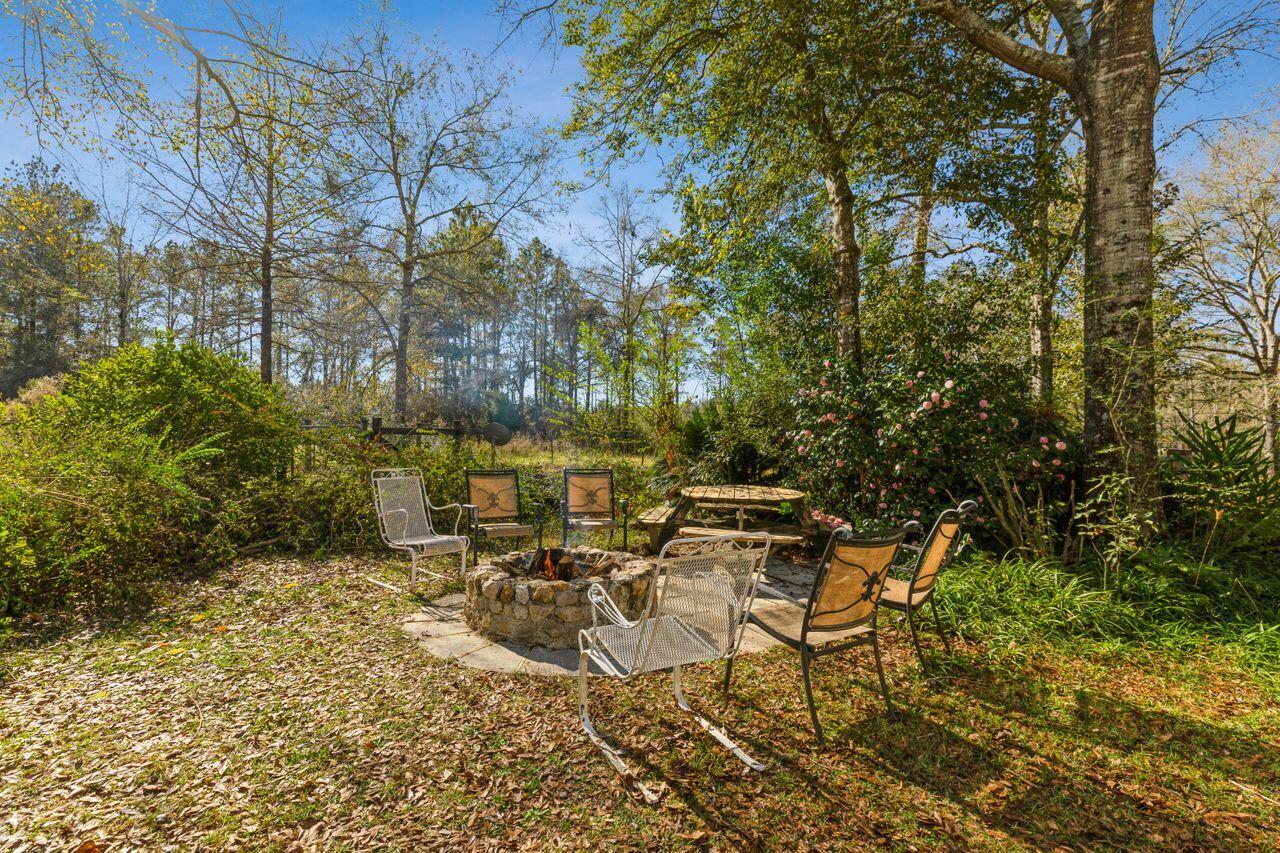 6391 Lumber Ridge Road Crestview, FL 32539 - Photo 26 of 48 a view of a patio with table and chairs and potted plants