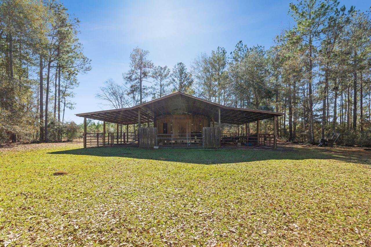 6391 Lumber Ridge Road Crestview, FL 32539 - Photo 30 of 48 a front view of a house with a large pool and a yard
