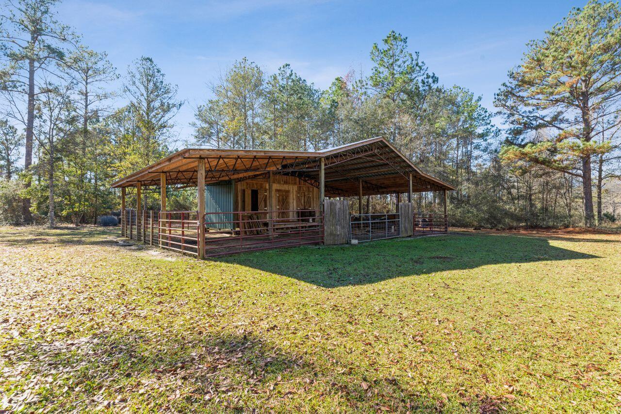 6391 Lumber Ridge Road Crestview, FL 32539 - Photo 31 of 48 a view of house with yard entertaining space and swimming pool