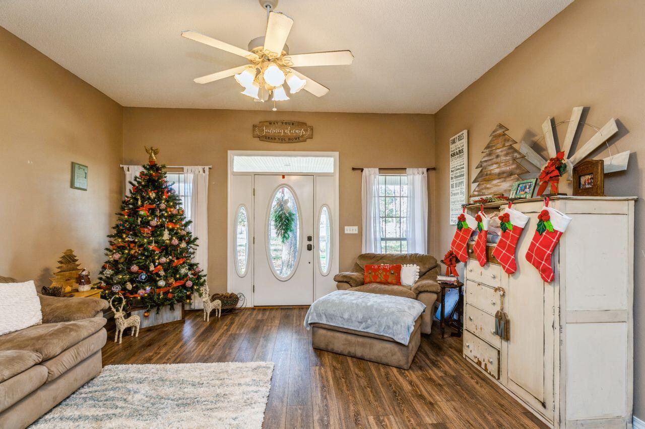 6391 Lumber Ridge Road Crestview, FL 32539 - Photo 6 of 48 a bedroom with furniture and a chandelier