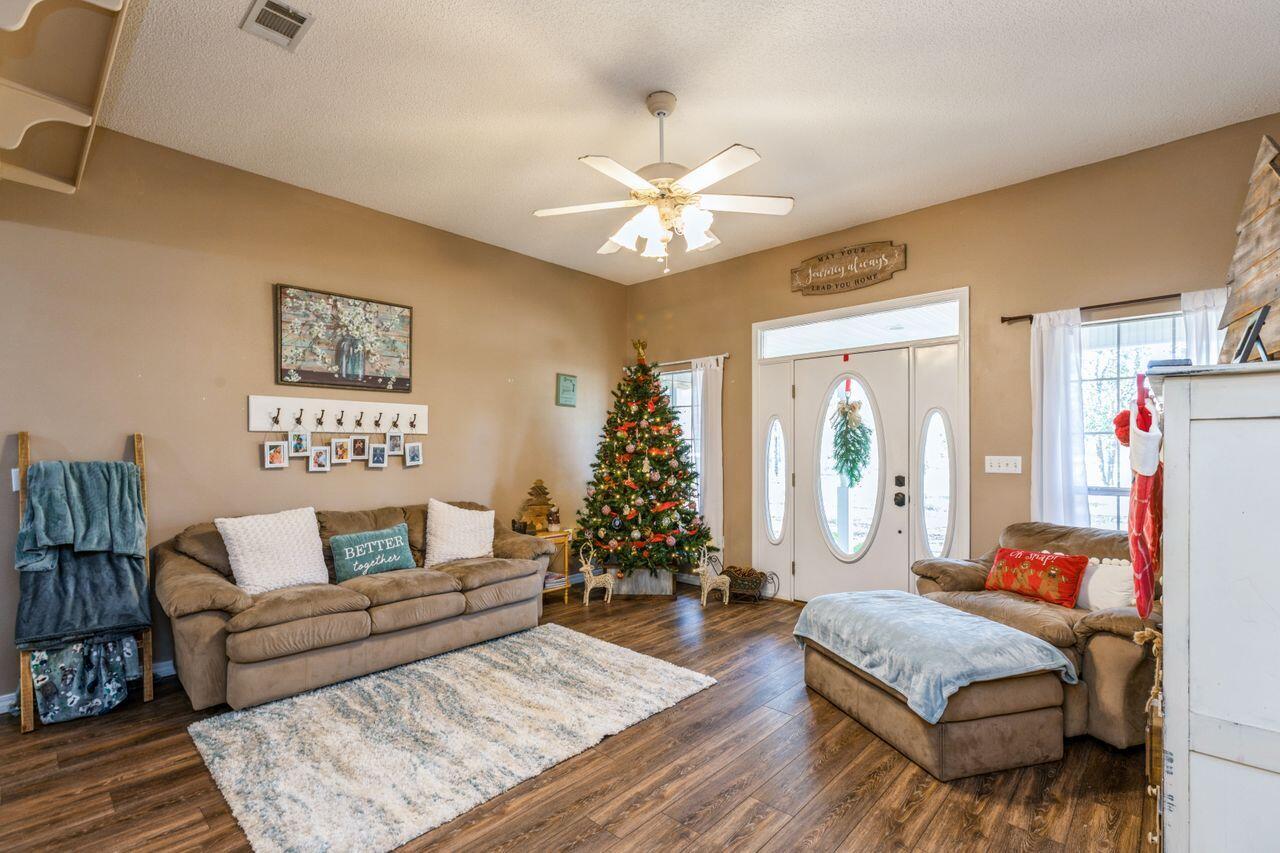 6391 Lumber Ridge Road Crestview, FL 32539 - Photo 7 of 48 a living room with furniture and a chandelier