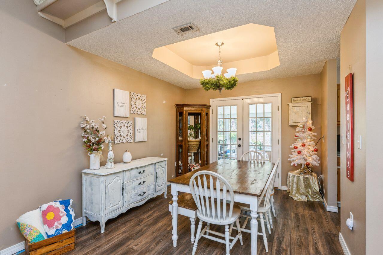 6391 Lumber Ridge Road Crestview, FL 32539 - Photo 8 of 48 a view of a dining room with furniture a chandelier and wooden floor