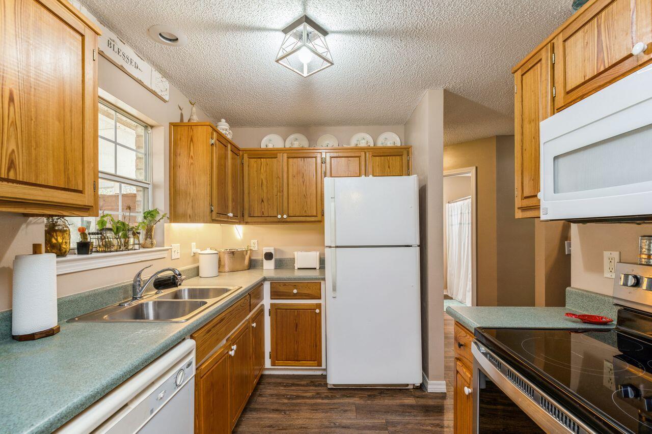 6391 Lumber Ridge Road Crestview, FL 32539 - Photo 10 of 48 a kitchen with a sink a stove and refrigerator