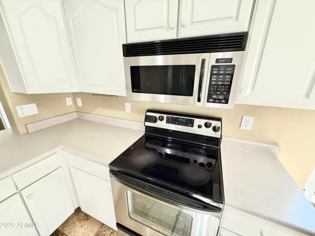 a stove top oven sitting inside of a kitchen