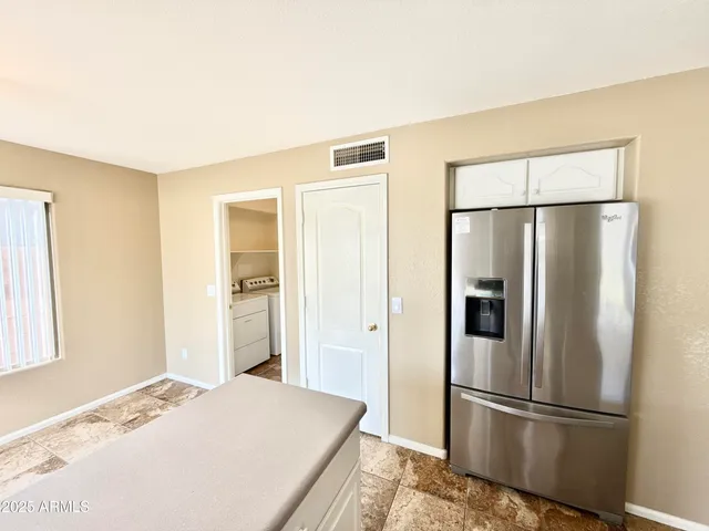 a kitchen with stainless steel appliances granite countertop a refrigerator and a sink