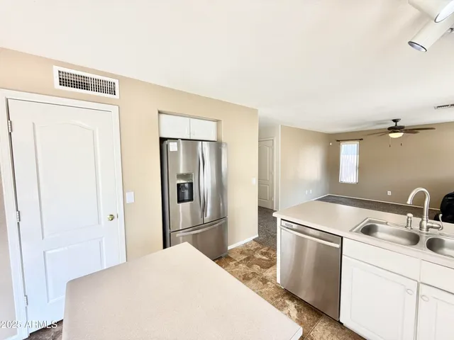 a kitchen with a sink and refrigerator