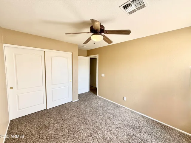 a view of a room with a ceiling fan