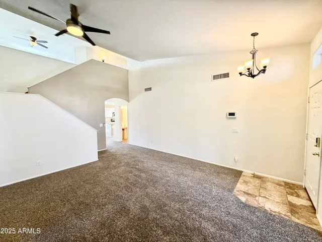 a view of a room with a ceiling fan