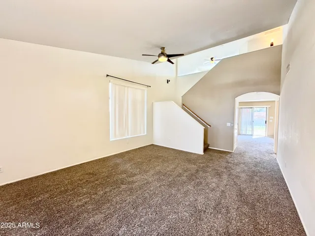 a view of a big room with closet and windows