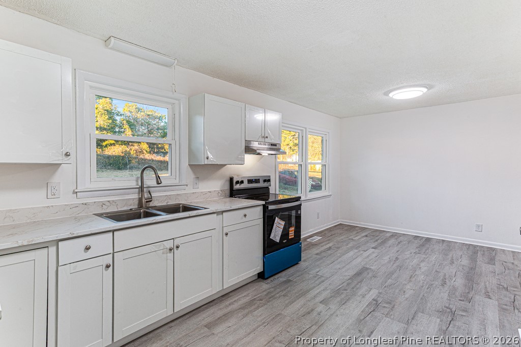 922 Rancho Drive Fayetteville, NC 28303 - Photo 12 of 21 a kitchen with a sink cabinets stainless steel appliances and a window