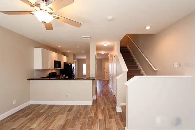 a view of a kitchen with a sink and a ceiling fan