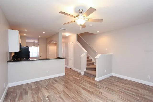 a view of a kitchen with a sink and a ceiling fan