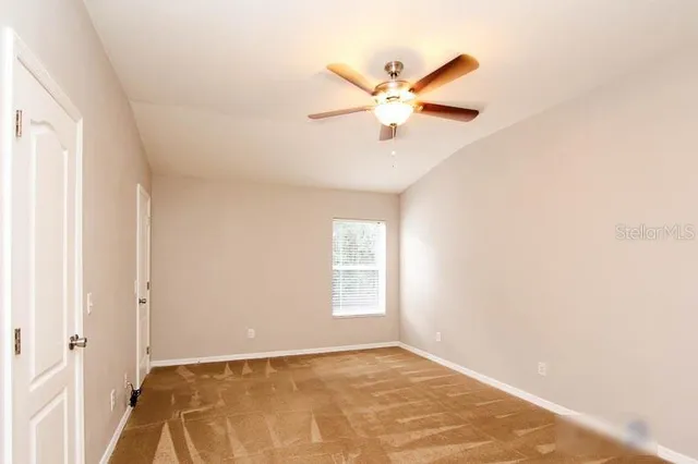 a view of a big room with wooden floor and windows in a room