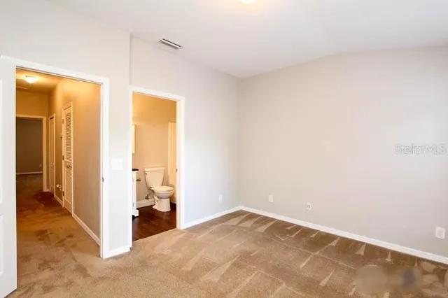 a view of a room that has a bed and a window