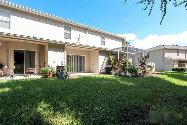 a front view of a house with a yard porch and outdoor seating