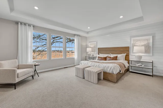 a bedroom with a bed and a couch with window