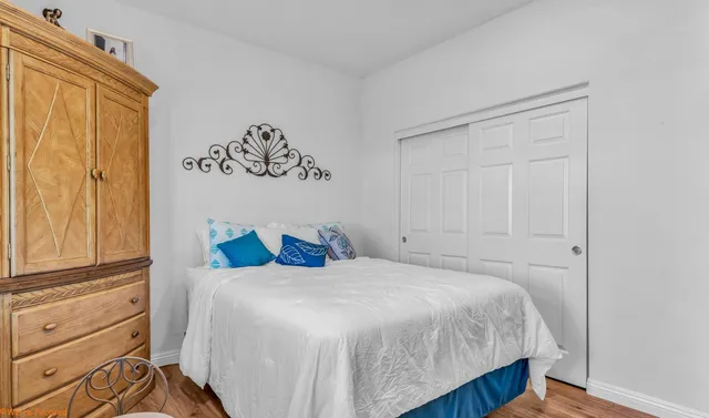 a bedroom with a bed dresser and a window