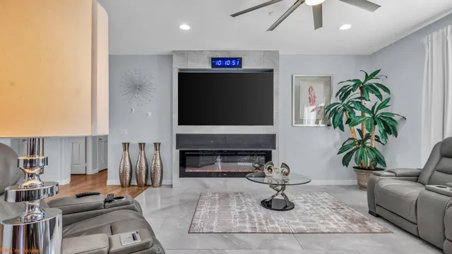 a living room with furniture a fireplace and potted plants