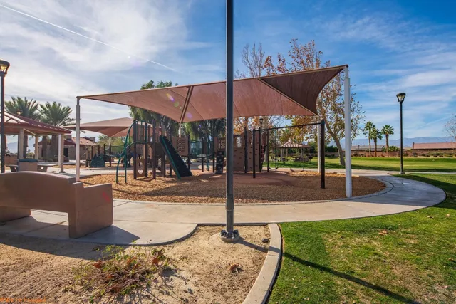 a view of swimming pool with palm trees