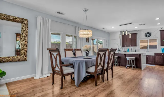 a dining room with furniture a window and wooden floor