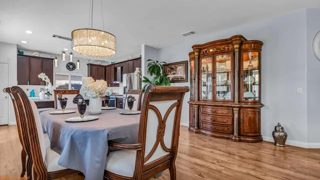 a kitchen with granite countertop a sink appliances cabinets and furniture