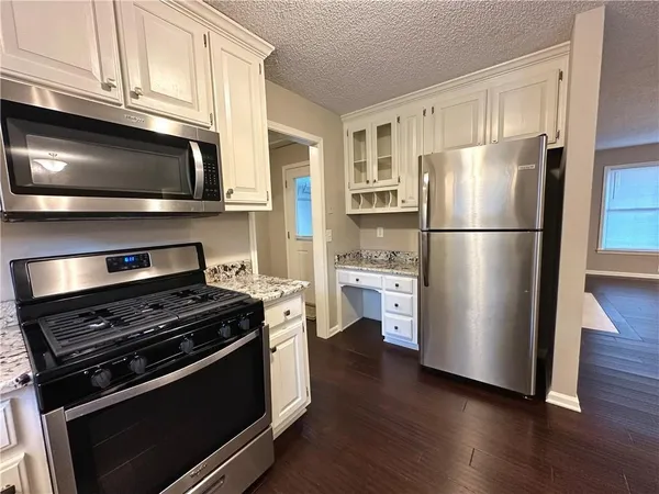a kitchen with wooden cabinets and stainless steel appliances