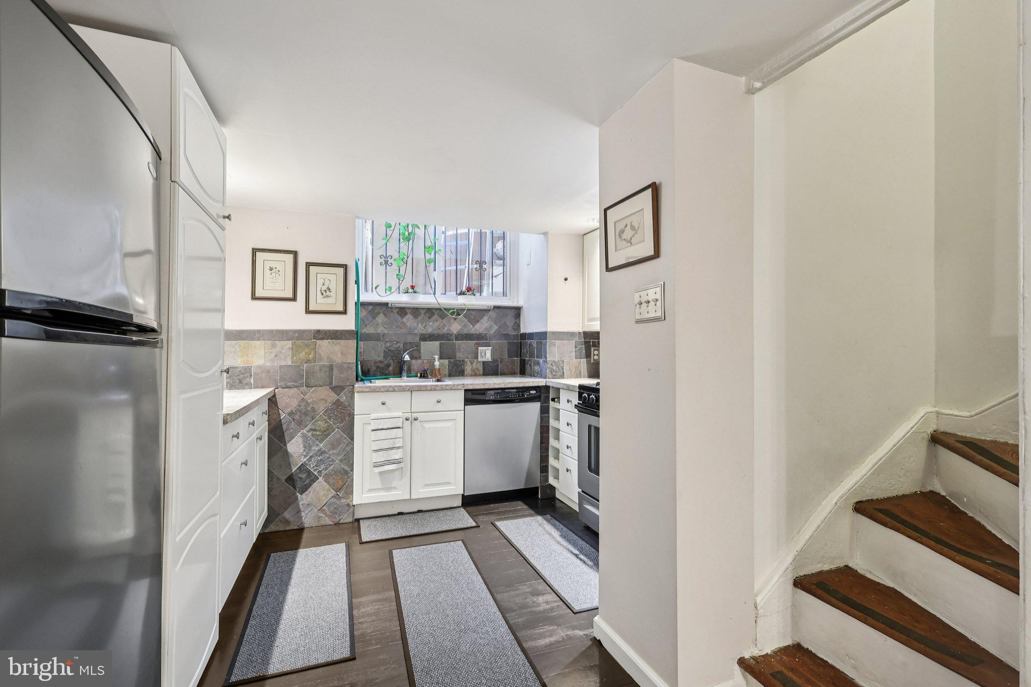 523 South Leithgow Street Philadelphia, PA 19147 - Photo 13 of 35 a kitchen with a refrigerator sink and stove