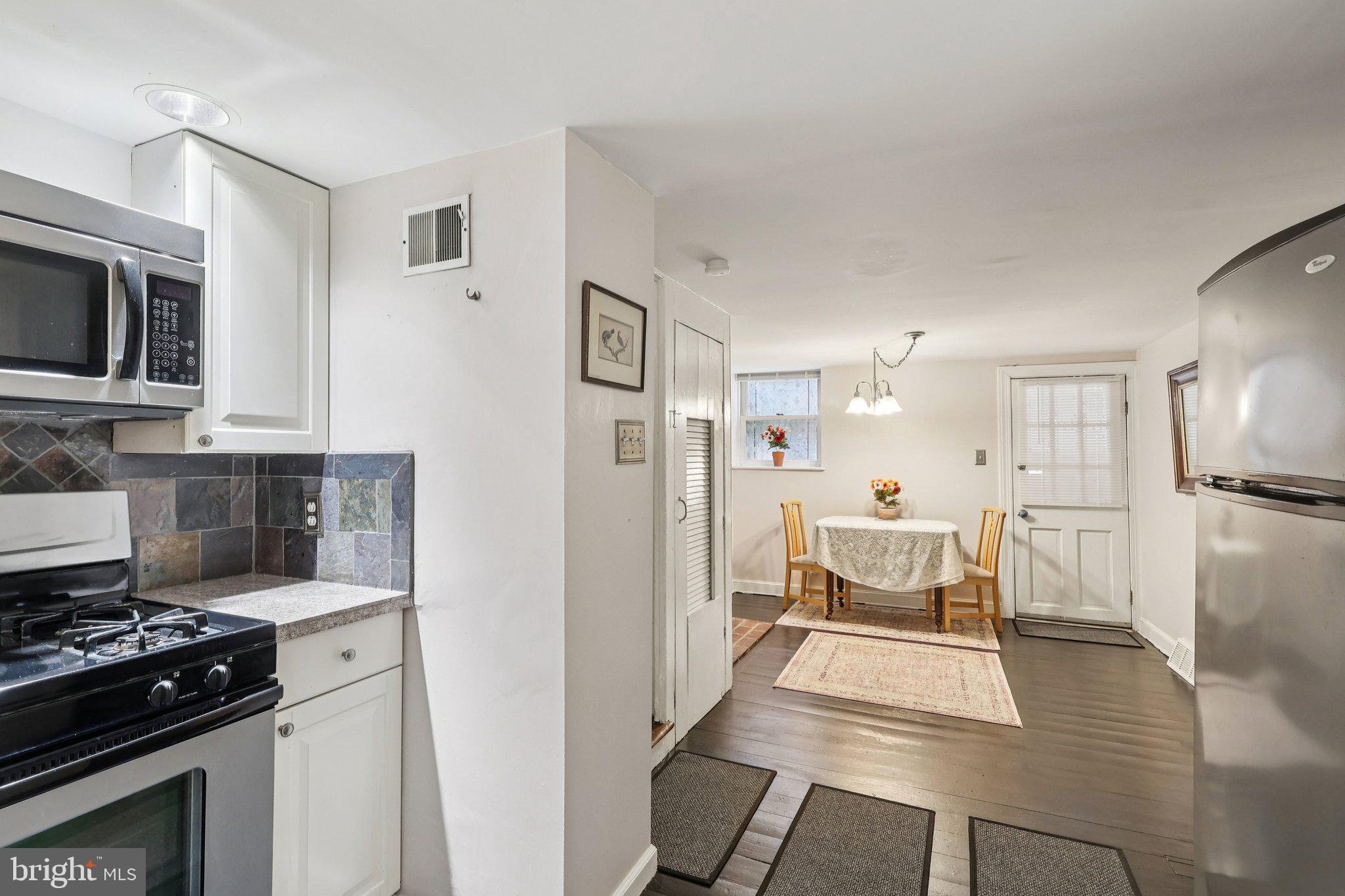 523 South Leithgow Street Philadelphia, PA 19147 - Photo 14 of 35 a kitchen with stainless steel appliances kitchen island granite countertop a refrigerator stove top oven and sink