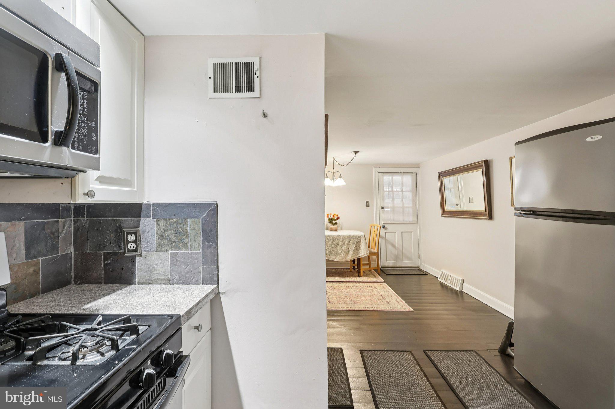 523 South Leithgow Street Philadelphia, PA 19147 - Photo 15 of 35 a kitchen with granite countertop a stove and a refrigerator