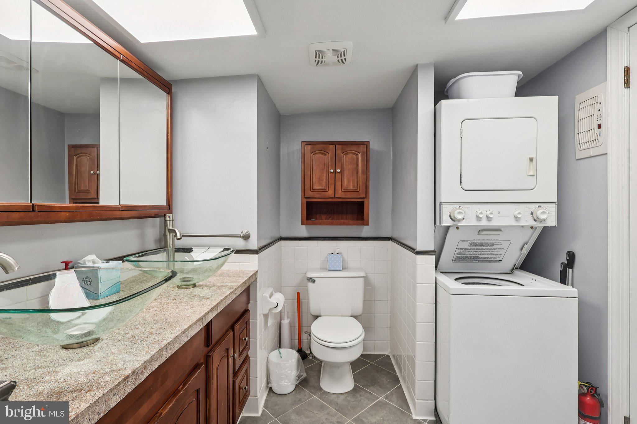 523 South Leithgow Street Philadelphia, PA 19147 - Photo 24 of 35 a bathroom with a granite countertop toilet sink and mirror