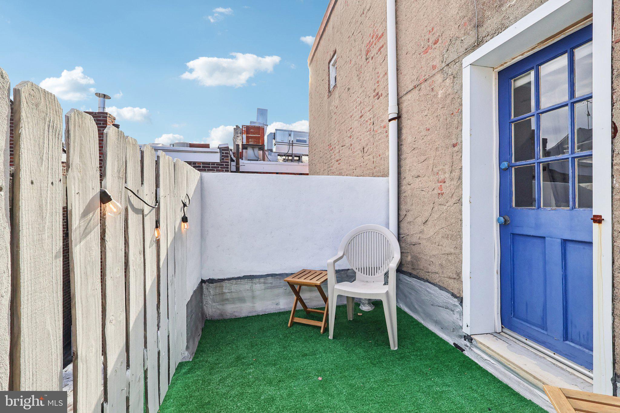 523 South Leithgow Street Philadelphia, PA 19147 - Photo 29 of 35 a view of a chair and table in backyard of the house