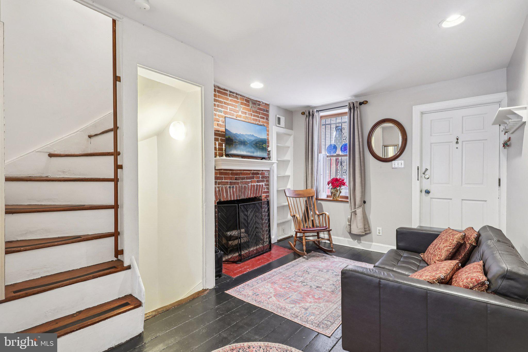 523 South Leithgow Street Philadelphia, PA 19147 - Photo 5 of 35 a living room with furniture a fireplace and wooden floor