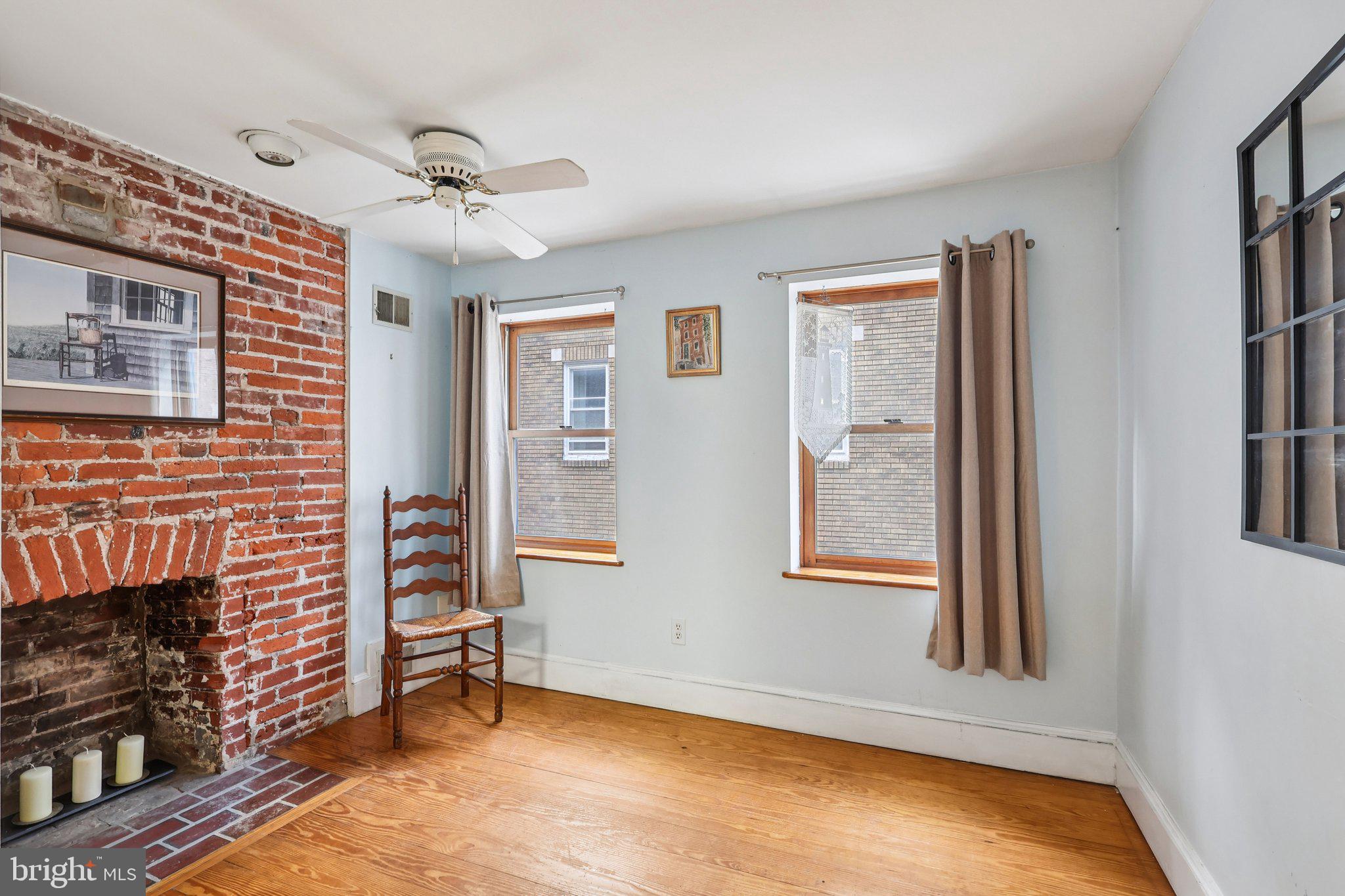 523 South Leithgow Street Philadelphia, PA 19147 - Photo 10 of 35 a view of an empty room with a fireplace and a window