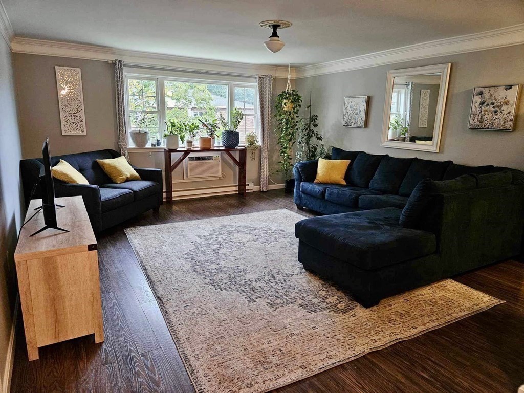 35 Berlin Street, Unit 218 Clinton, MA 01510 - Photo 2 of 13 a living room with furniture and a rug