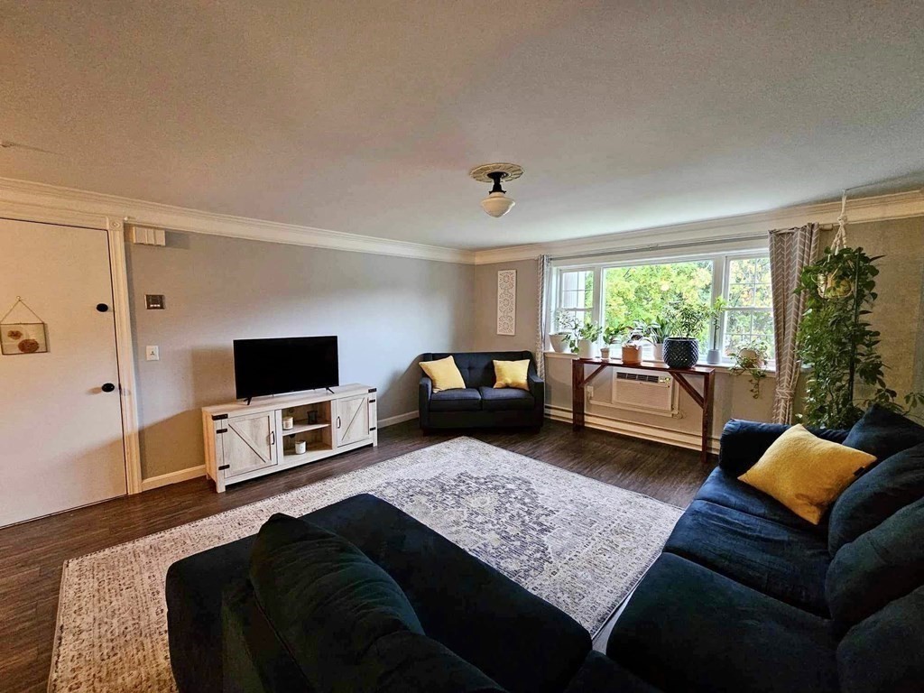 35 Berlin Street, Unit 218 Clinton, MA 01510 - Photo 3 of 13 a living room with furniture and a flat screen tv