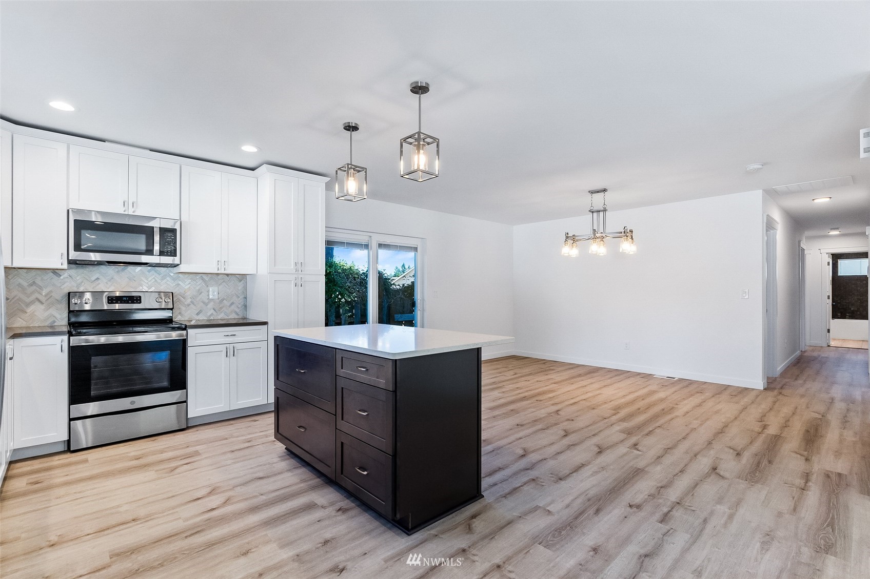 9815 178th Way Southwest Rochester, WA 98579 - Photo 6 of 35 a kitchen with stainless steel appliances granite countertop a stove a sink and a refrigerator
