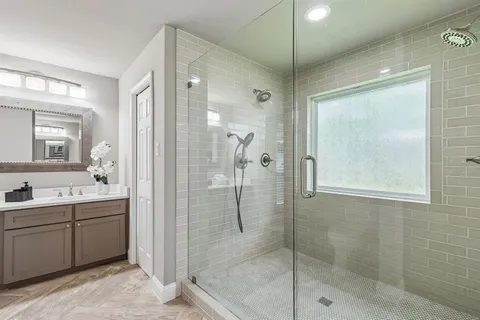 a bathroom with a shower and a sink